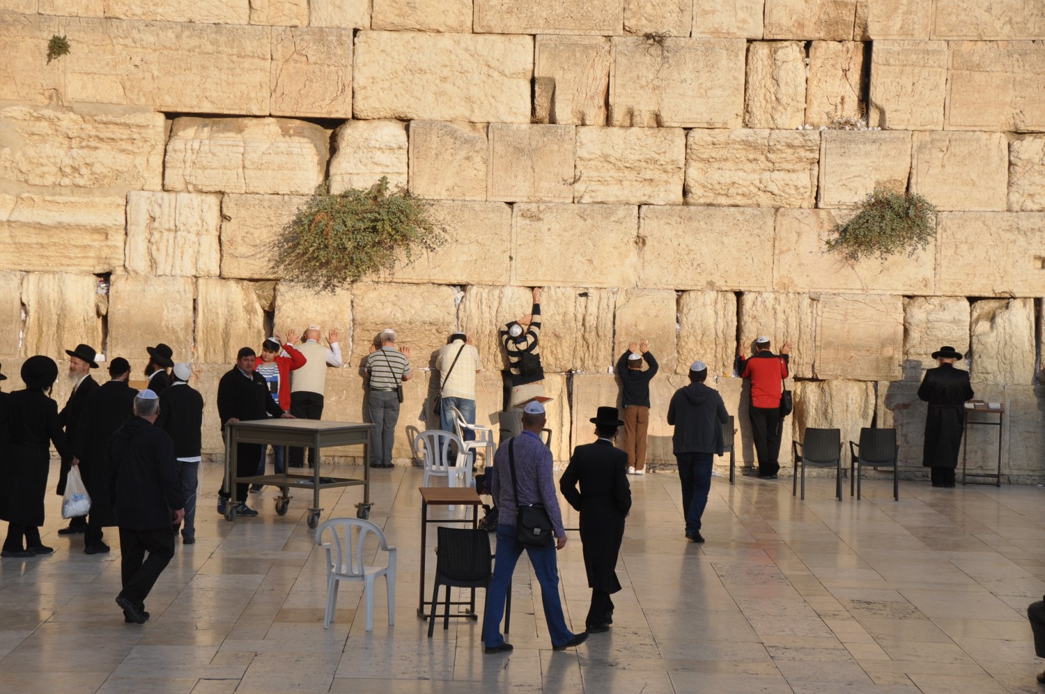 People putting prayers in the cracks of the Wailing Wall
