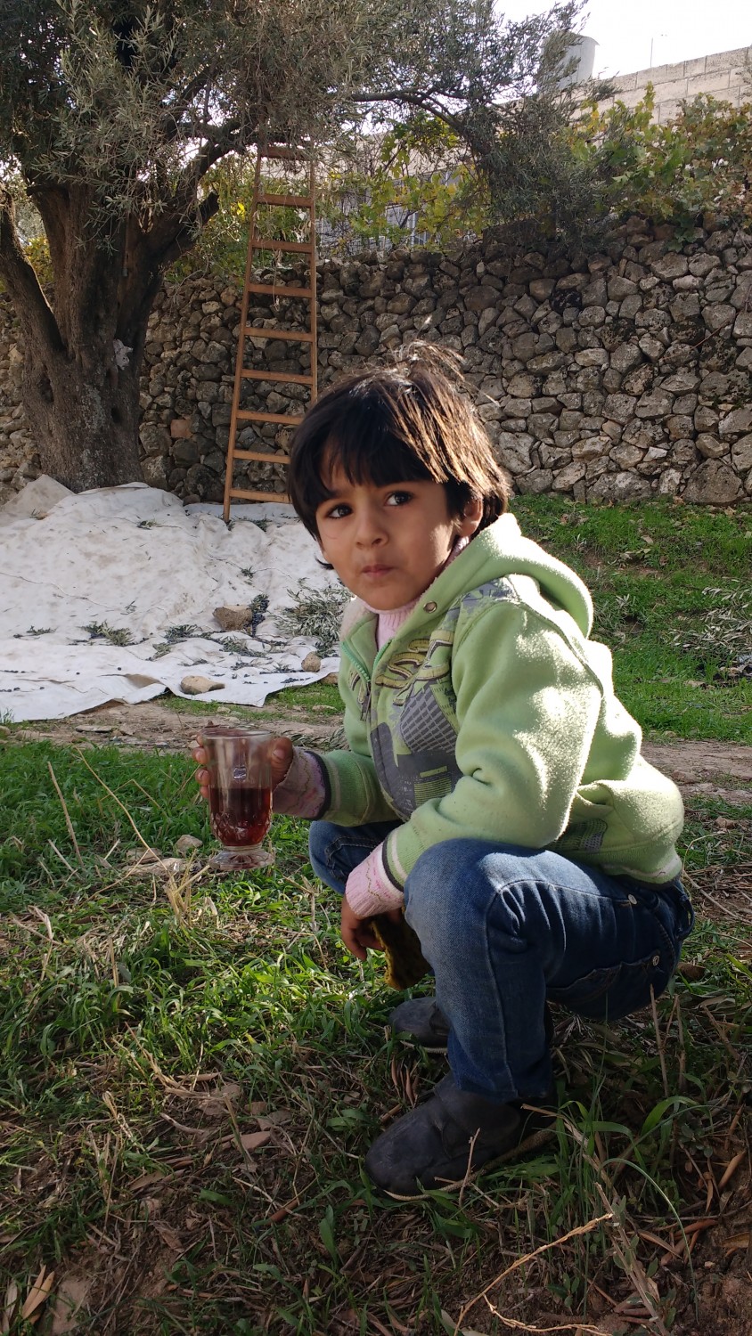 Palestinian kid drinking some sugary tea